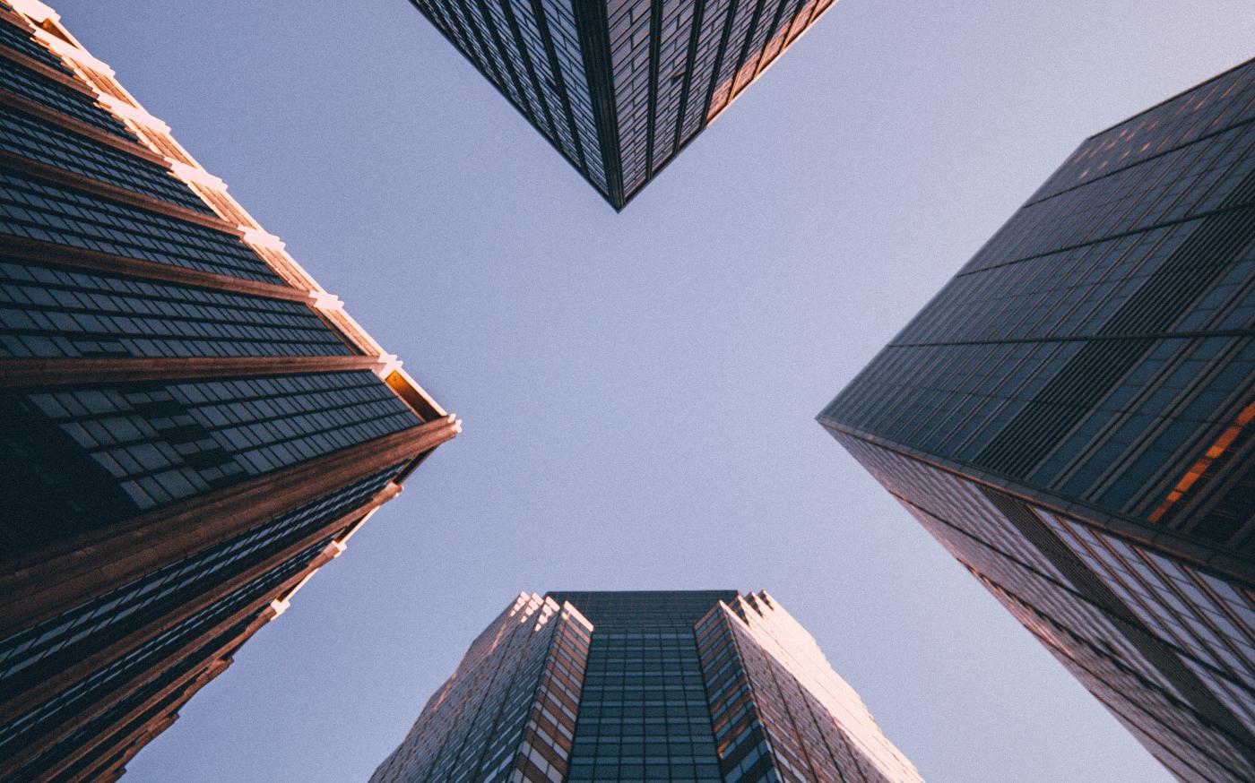 low-angle photography of four high-rise buildings by Kevin Matos courtesy of Unsplash.